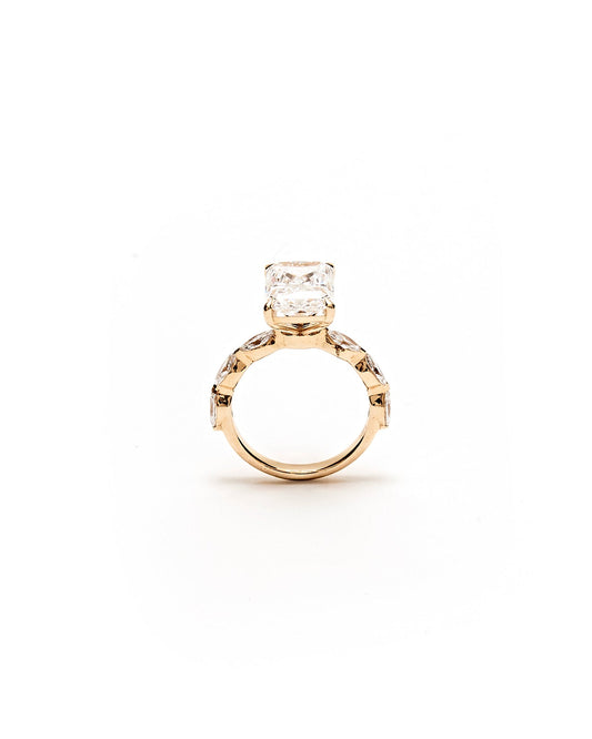 Gold ring with a diamond on a white background