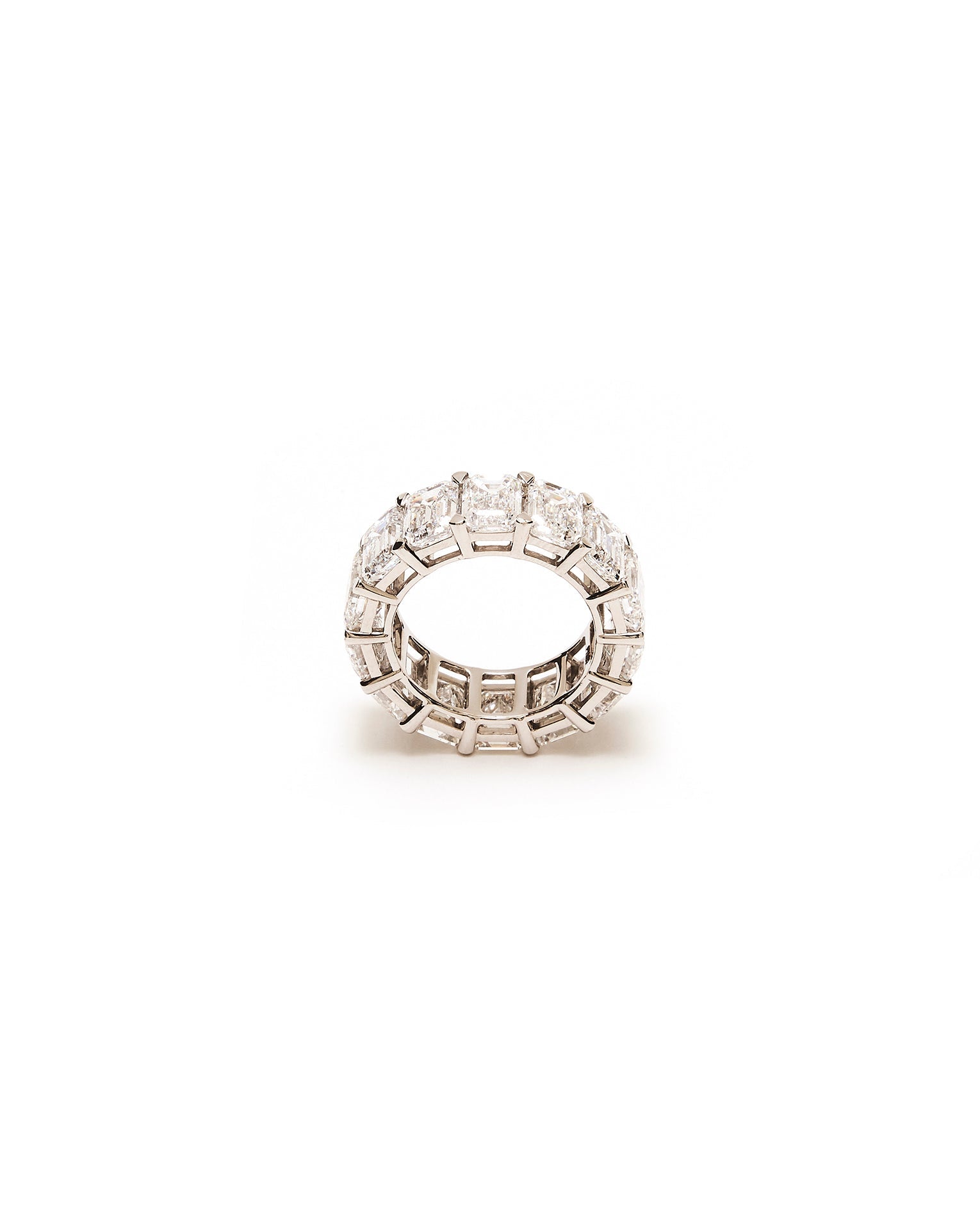 Silver ring with embedded diamond stones on a white background