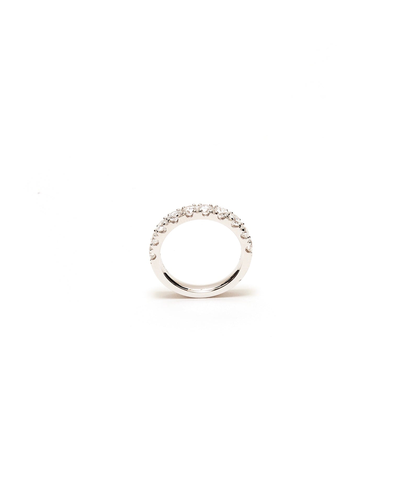 Silver ring with small diamond stones on a white background