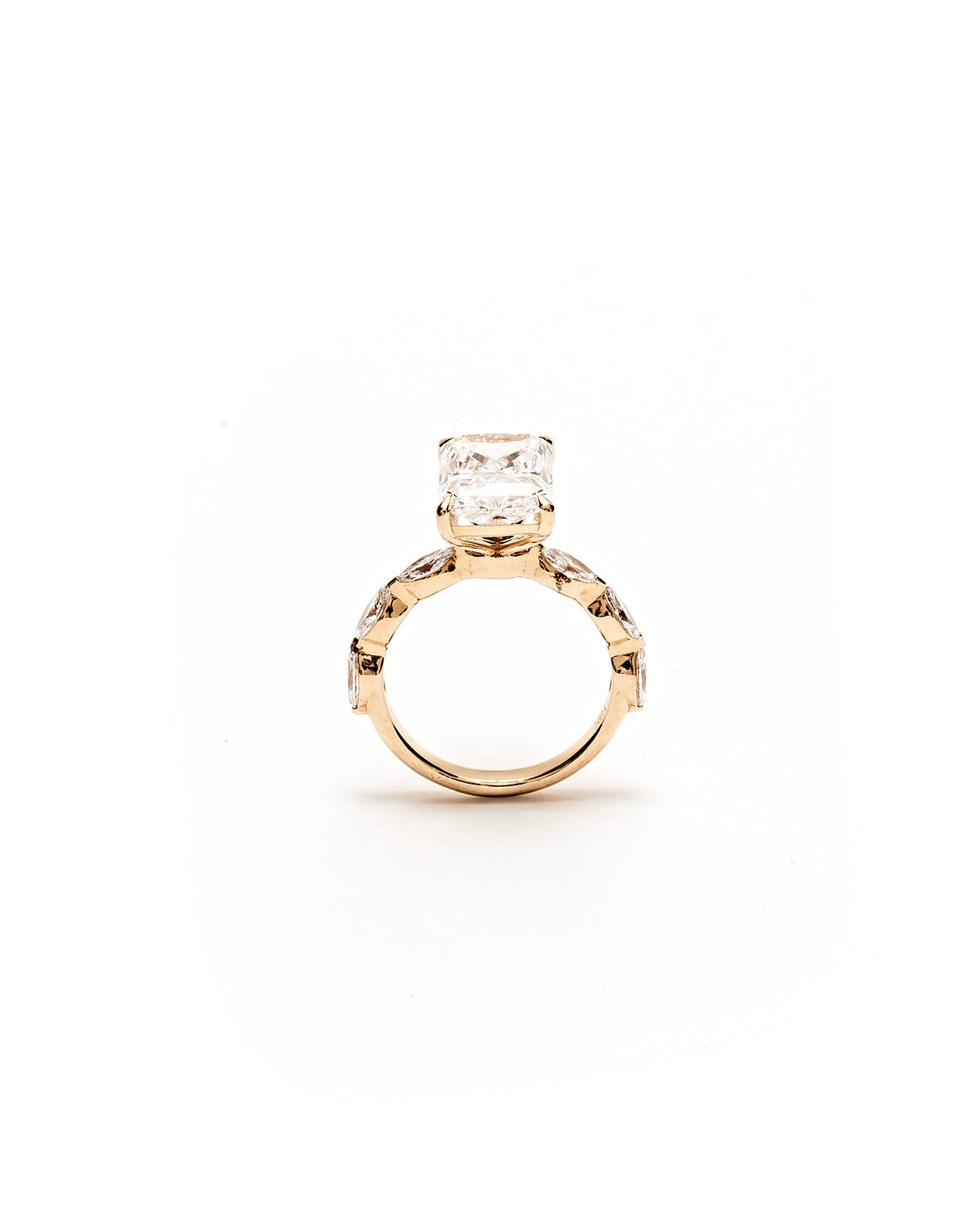 Gold ring with a diamond on a white background